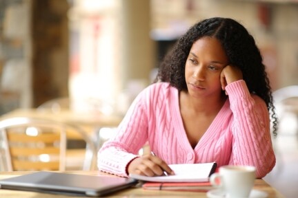 ADHD as an introvert blog banner showing a lonely girl sitting on a bridge looking out at the ocean